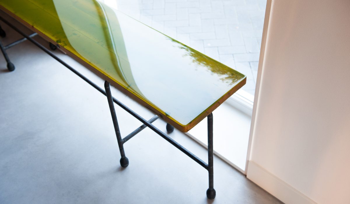 Stalen sidetable met houten tafelblad in gekleurd epoxy in een uniek industrieel design